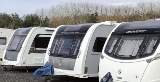 4 white caravans in a caravan park