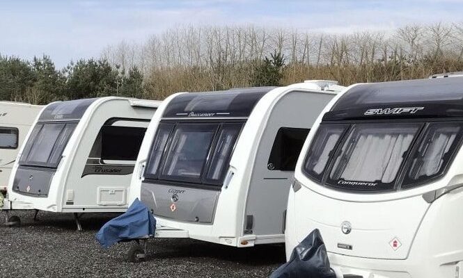 4 white caravans in a caravan park